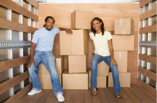 couple in a moving truck with boxes